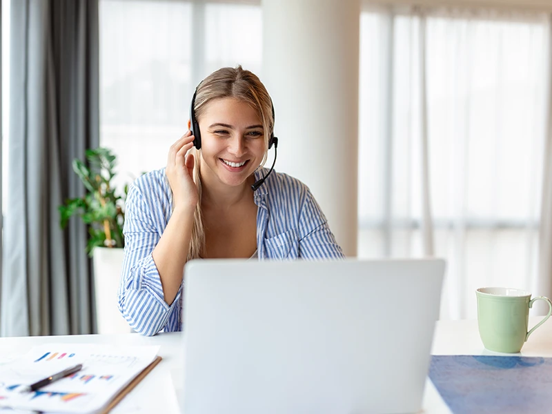 Kundenservice-Mitarbeiterin mit Headset: Fahrzeughistorie prüfen mit Geld-zurück-Garantie bei Cardentity
